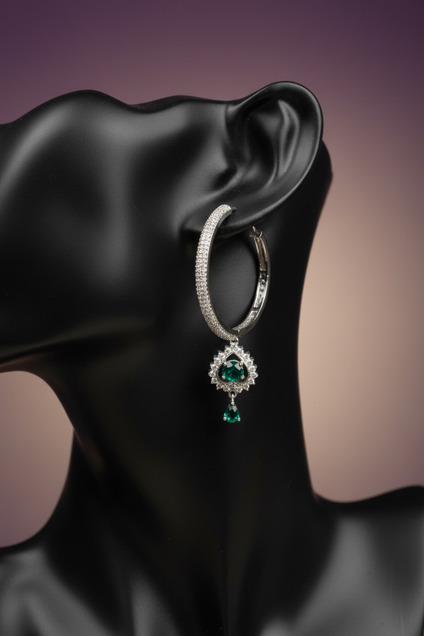 Emerald CZ hoop earrings on black mannequin